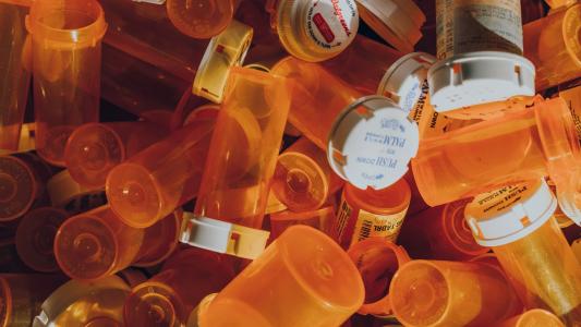 A pile of empty prescription pill bottles.