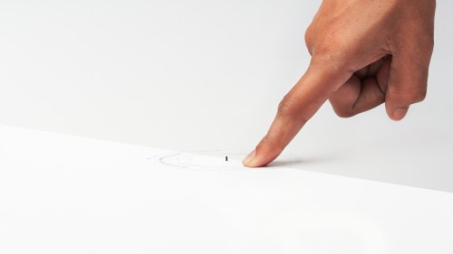 Photo of a hand point to a tiny medical robot. Credit: Bionaut Labs