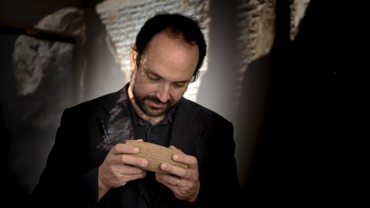 Professor Enrique Jiménez studying a cuneiform tablet