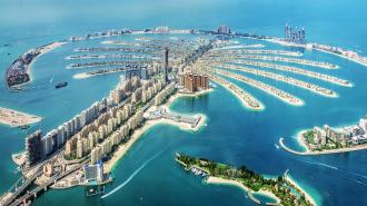 a large artificial island shaped like a palm tree off an urban coastline