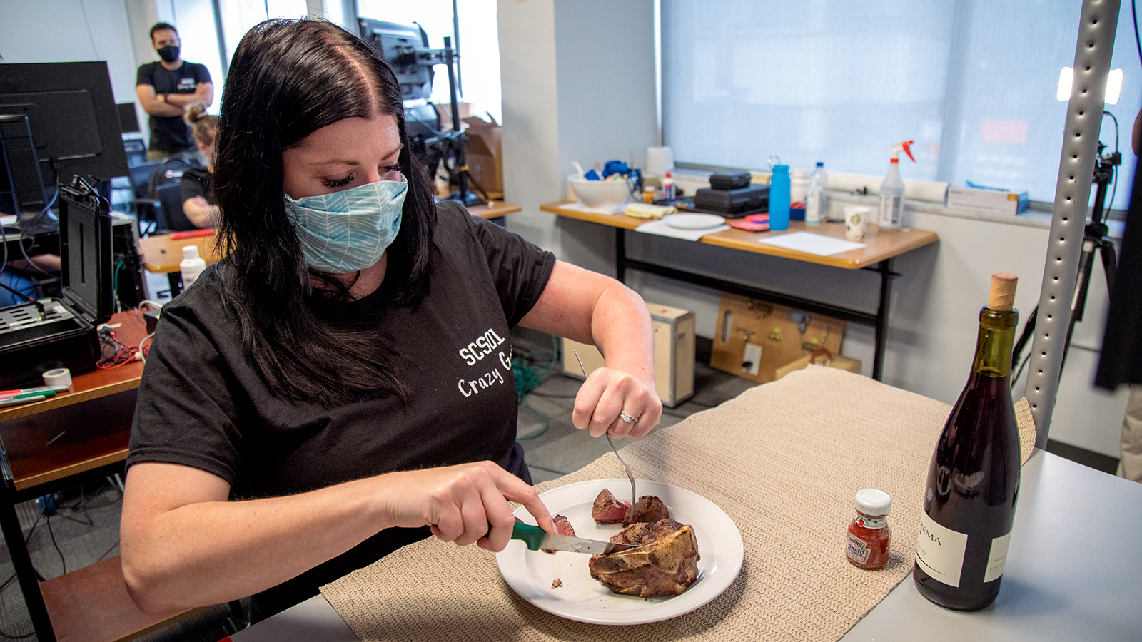 a stroke survivor cutting into a steak