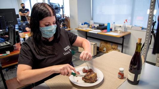 a stroke survivor cutting into a steak