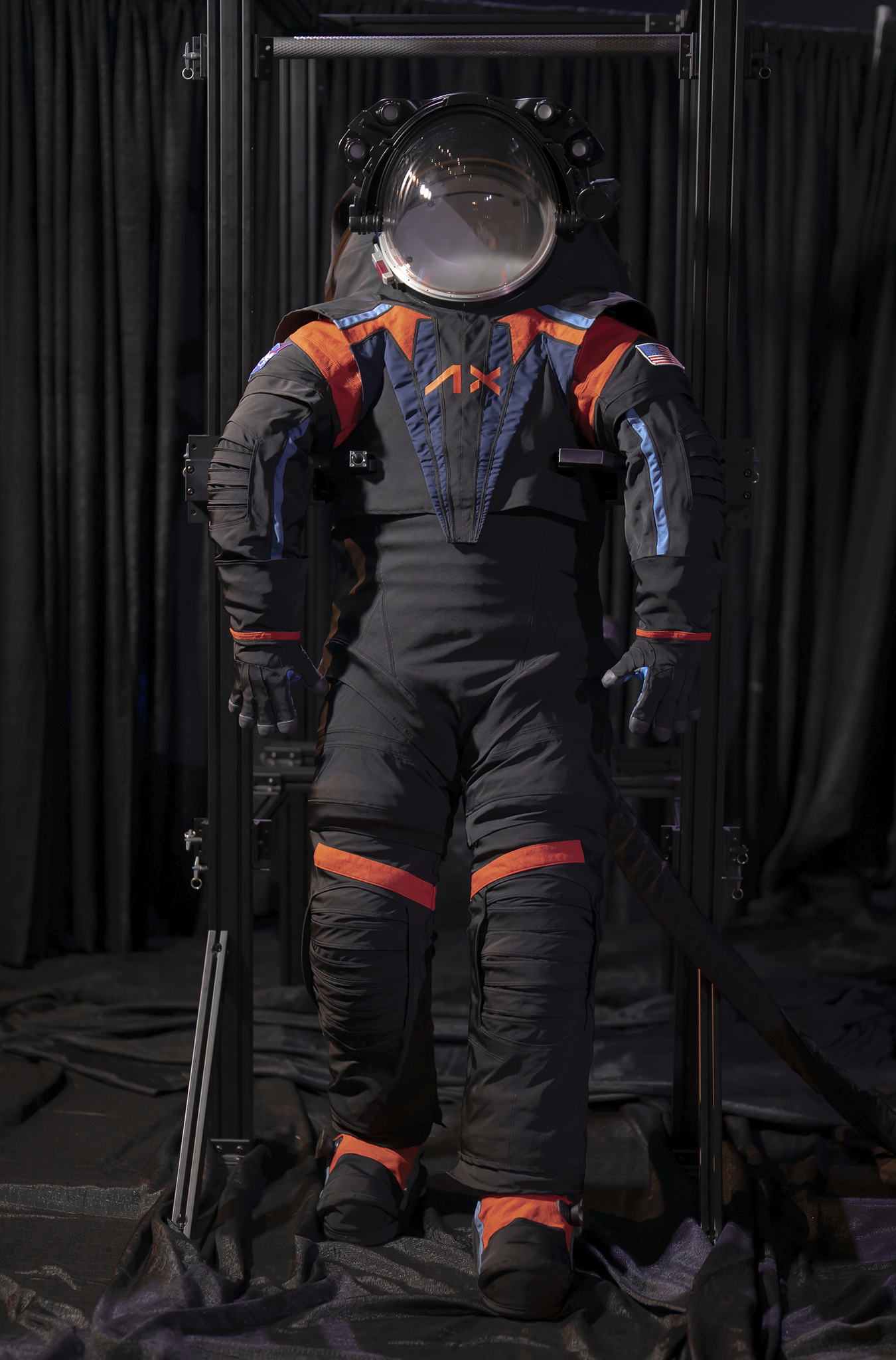 a black spacesuit with blue and orange features