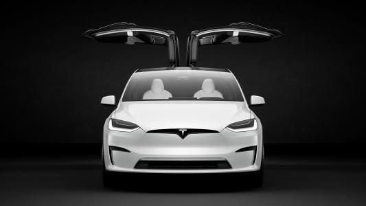 an image of a tesla from the front with its doors open