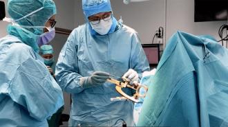 doctors in lab coats performing a procedure on a patient