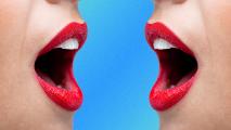a close up of two open mouths facing one another