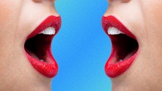 a close up of two open mouths facing one another