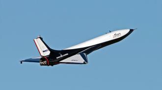 a spaceplane flying across a blue sky