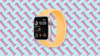 an iwatch with a yellow band on a pattern of pink dumbbells