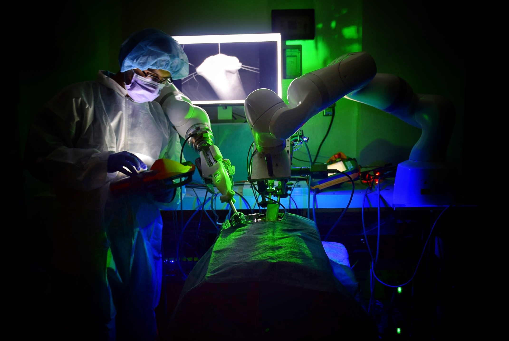 a doctor observing a robot performing surgery
