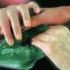 A cancer patient's hand is comforting another person's hand.