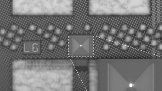 a closeup of a tiny LED in the middle of a microchip