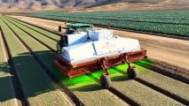 a tractor with a green light in the middle of a field.