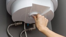 A person installing a water heater.