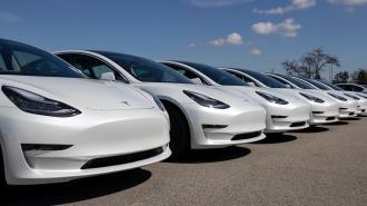 a row of parked Teslas