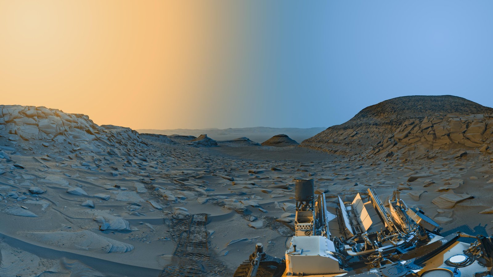 mars' surface with the left side of the image toned yellow and the right side blue