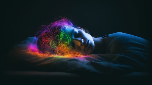 an image of a person sleeping with colorful squiggles representing their brain activity