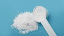 a white powder with a scooper on a blue background