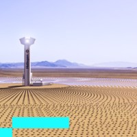A solar tower in the middle of a desert.