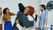 A group of people demonstrating their meta skills in a studio while hugging.