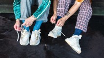 A tutorial video demonstrating how to tie shoes on a couch.