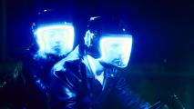 Two men wearing helmets with blue lights on them on a ride.