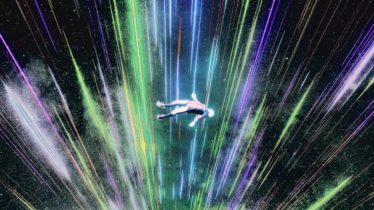 An image of a man flying through a vibrant cosmic expanse.