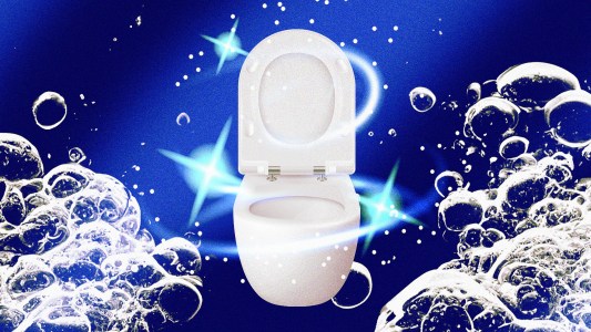 A slippery toilet bowl filled with bubbles in wastewater.
