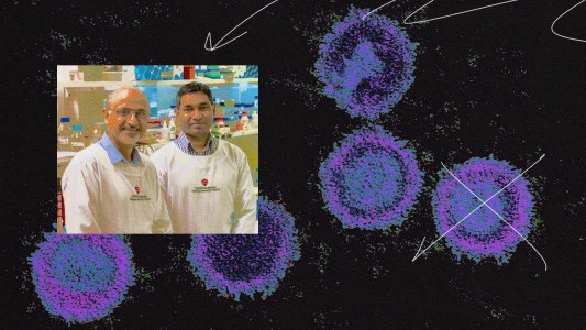 Two men in lab coats studying a drawing of coronaviruses, specifically focusing on the possible connection between EBV infection and the development of an EBV vaccine.