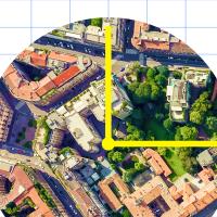 An aerial view of a city with a yellow arrow.