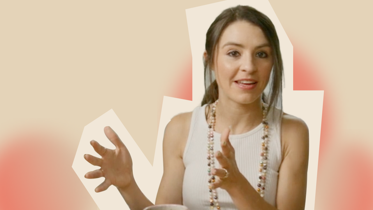 A woman is holding a cup of coffee.