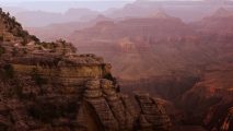 A person is standing on the edge of a cliff.
