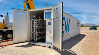 A large container for renewable energy storage with a crane attached to it.