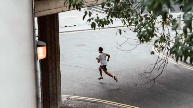 A man jogging on a street in london.