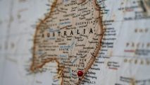 A map of australia with a red pin on it.