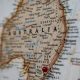 A map of australia with a red pin on it.