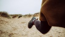 A person's feet in the sand.