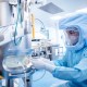 A person in a protective suit in a vaccine manufacturing facility