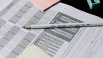 A pencil sits on top of a sheet of paper.