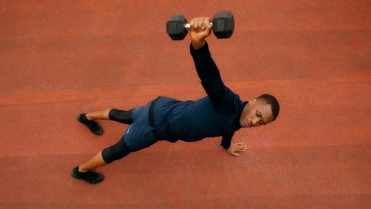 A man lifting a dumbbell to speed up his metabolism.