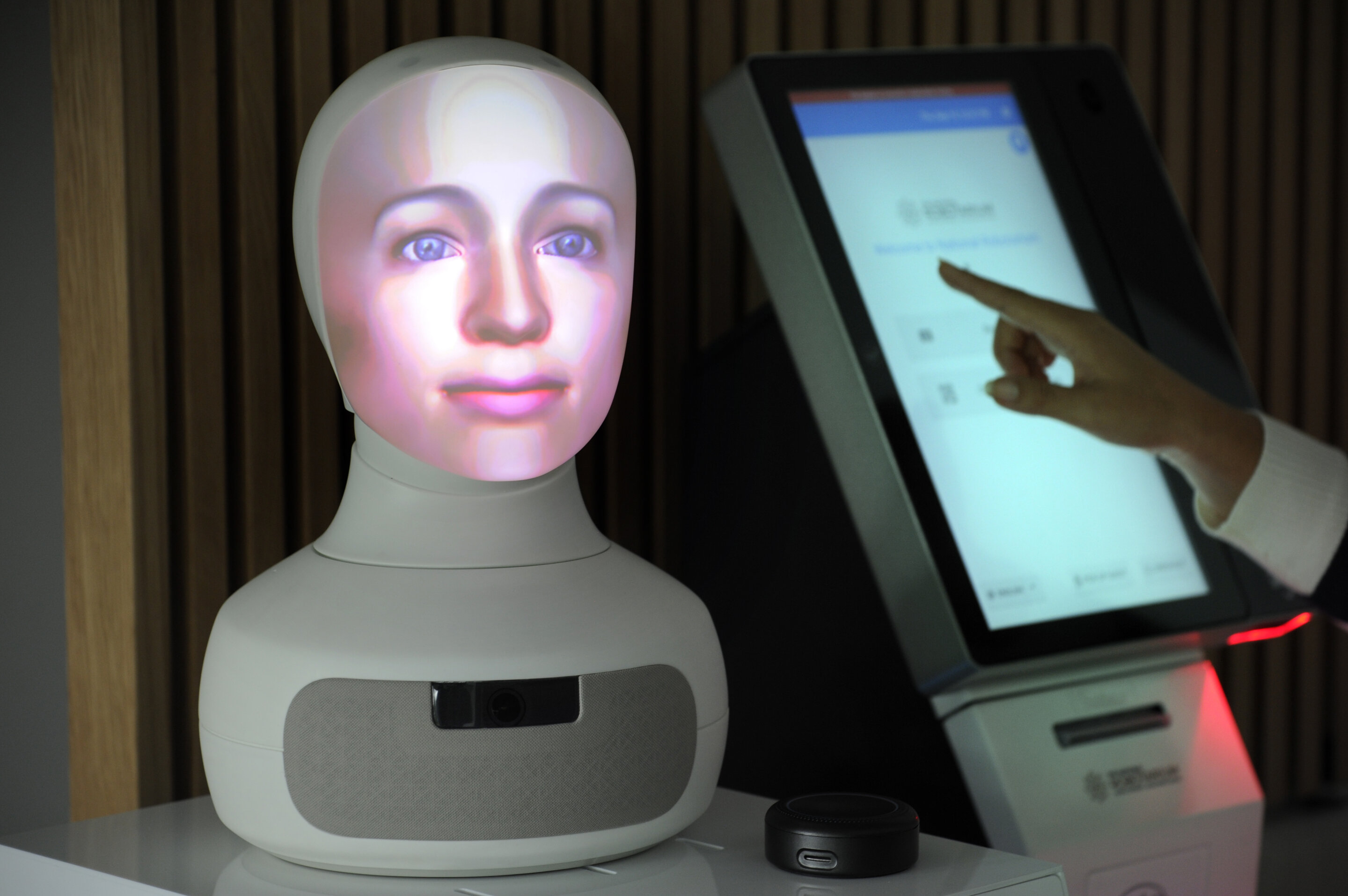 a humanoid bust next to a touchscreen