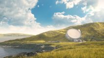 A satellite dish on a grassy hill near the ocean.
