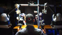 A man using a remote operation system to teach a robot a new task