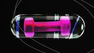 An image of a pink dumbbell inside a clear pill capsule.