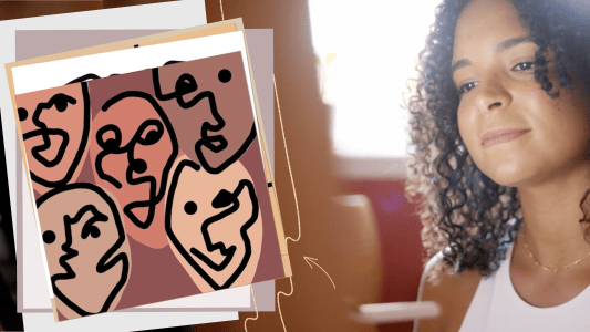 A woman with curly hair is looking at a drawing of faces.