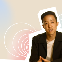 A man is sitting in front of a colorful background.