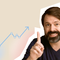 A man with a beard is pointing at a graph.