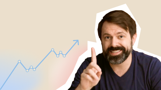 A man with a beard is pointing at a graph.