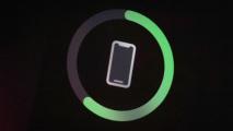 An iphone is shown with a green circle indicating it is charging.