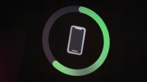 An iphone is shown with a green circle indicating it is charging.